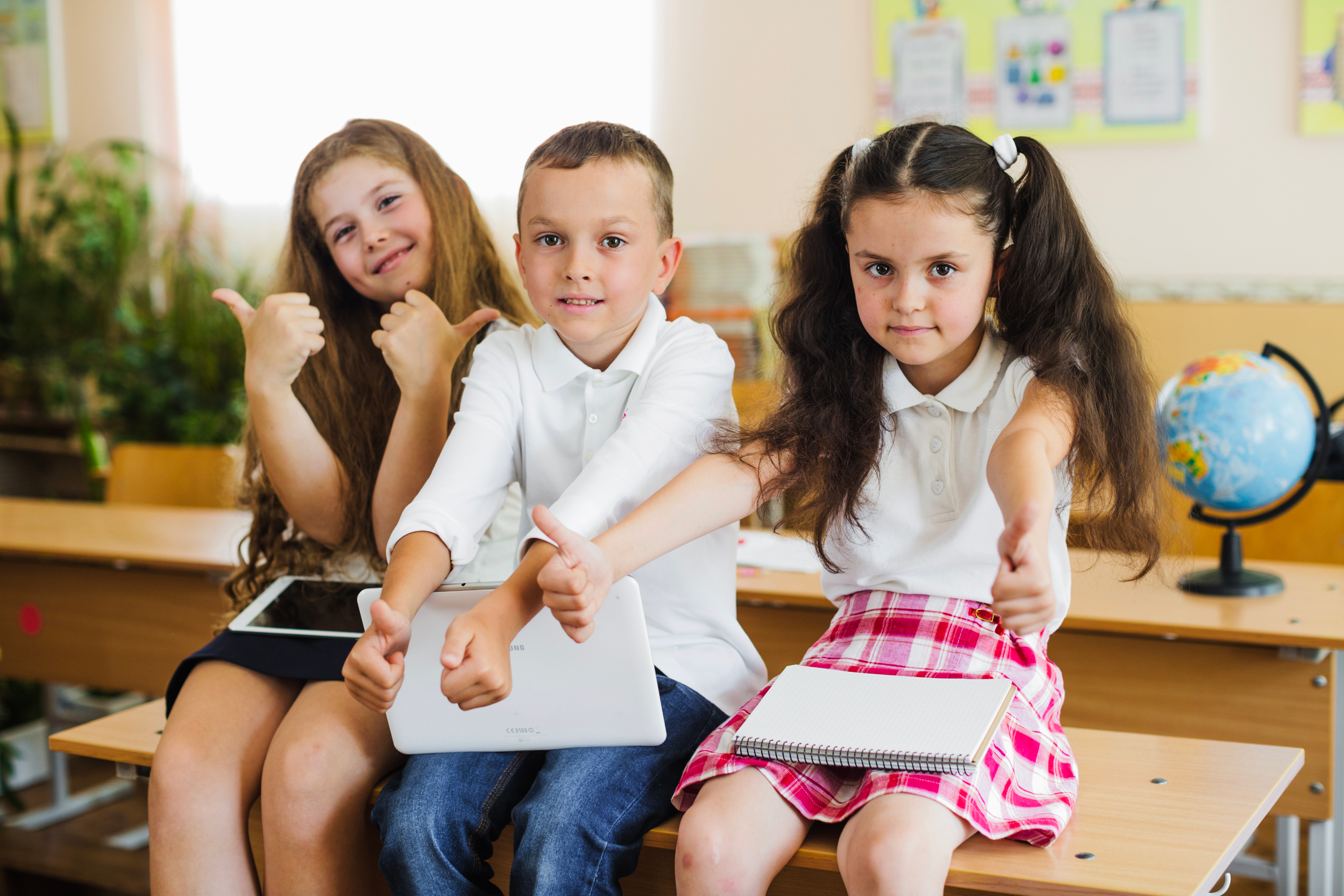 Pupils giving a thumbs up